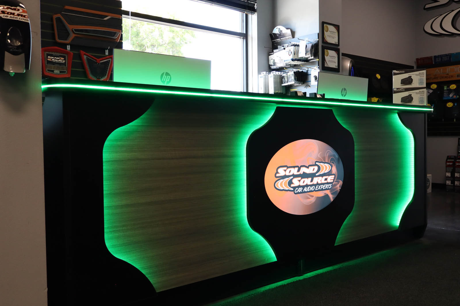Sound Source showroom counter with green accent lighting and the Sound Source logo