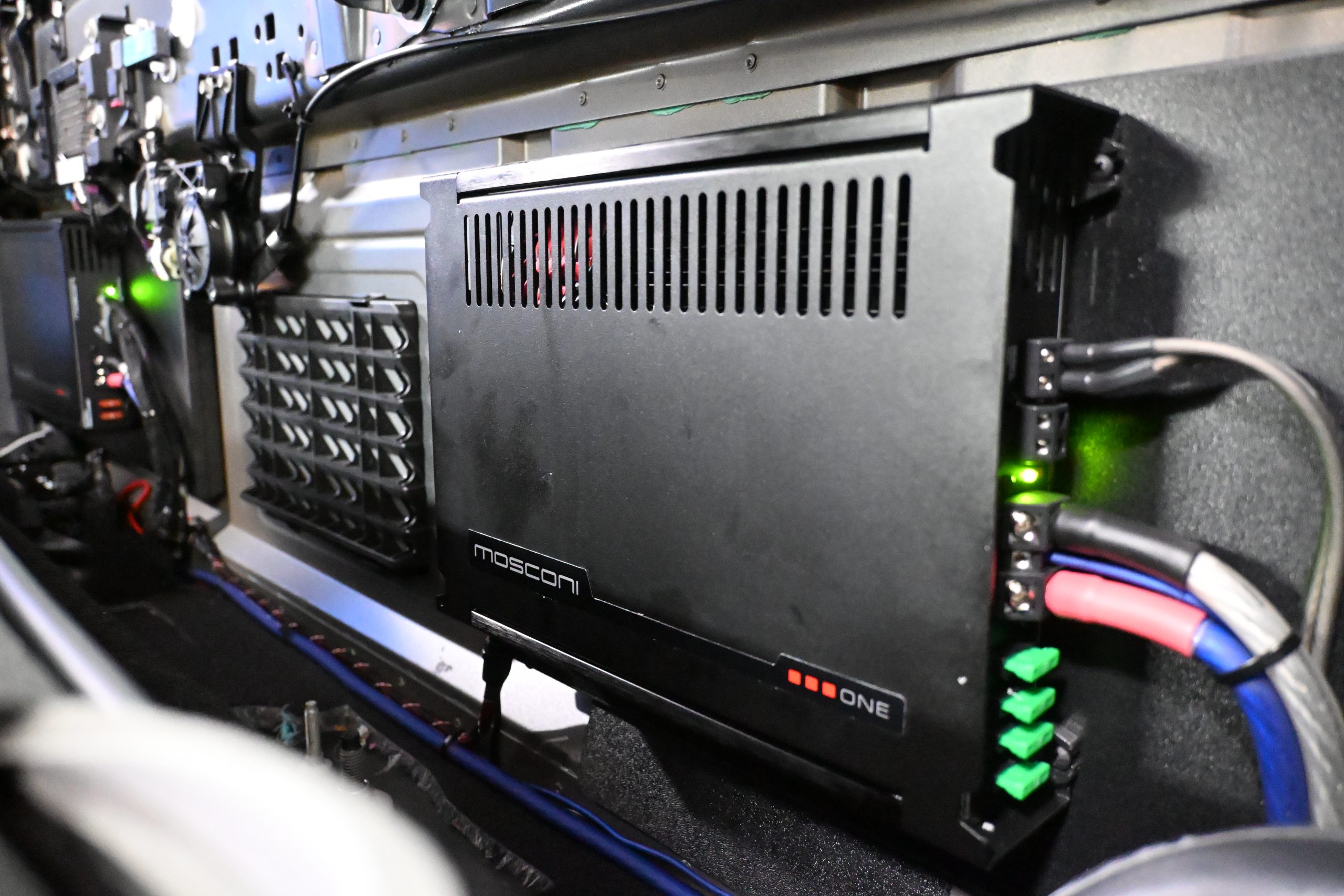 Car audio amplifier installation at Sound Source in Pocatello Idaho powering aftermarket speakers